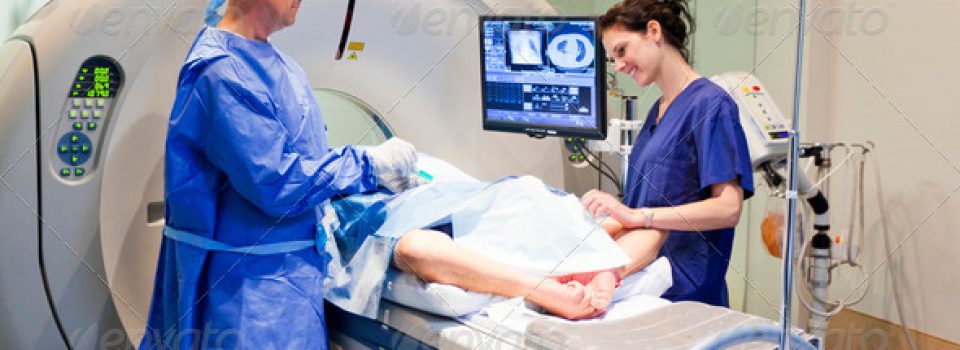 A man and woman in blue scrubs working on something.